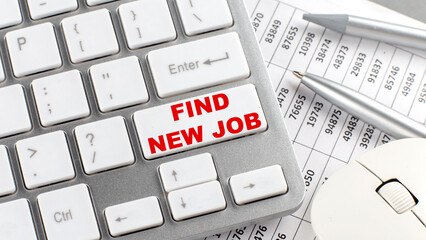 FIND NEW JOB text on a keyboard wirh chart and pencil