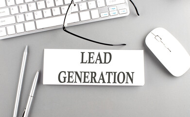 LEAD GENERATION text on paper with keyboard on grey background
