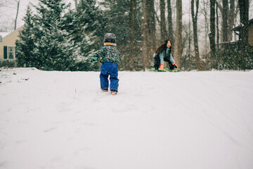 parent and child walking in the snow