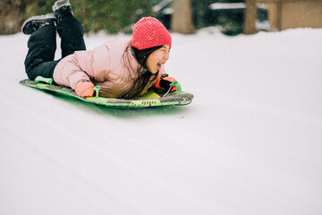 portrait of an asian girl playing in winter