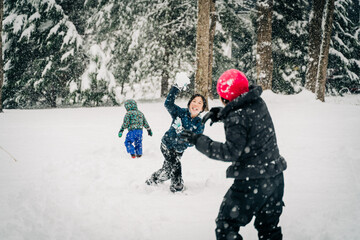 asian family playing in winter