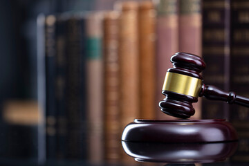 Law theme - judge office. Gavel and legal books on the judge desk. 