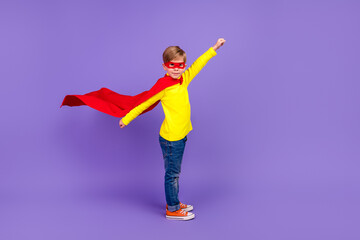 Full length photo of purposeful cute little grandson dressed red cape hurrying help isolated purple color background
