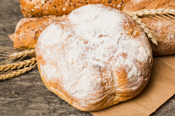 Homemade natural breads. Different kinds of fresh bread as background, perspective view with copy space