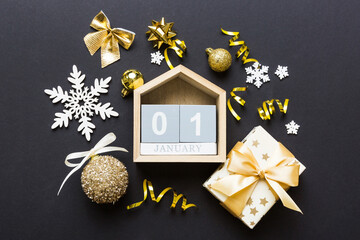Christmas calendar 1 january. Christmas gift, fir branches, pine cones. Flat lay, top view. New Year decorations on a colored background