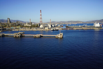 Fototapeta premium Terminal for loading gas onto ships. LNG equipment near sea Port terminal. Berth for unloading liquefied gas. Supply of liquefied gas