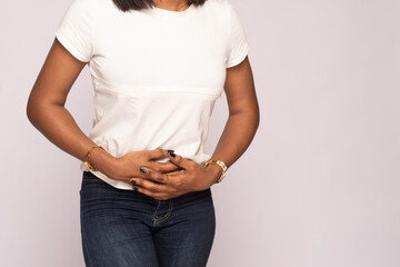 young black lady feeling discomfort in her stomach