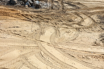 Traces from a large construction vehicle on the ground