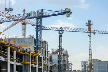 Fototapeta na wymiar Tower crane at the construction site of a multi-storey building.