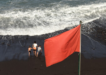Red flag is high hazard at sea and meaning high surf and/or strong currents, so people are strongly discouraged to enter the water.