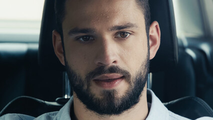 sweaty man suffering from heat while driving car in summer.