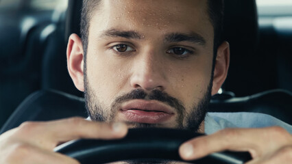 tired man with sweaty forehead driving car while suffering from heat. - obrazy, fototapety, plakaty