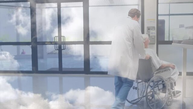 Animation of clouds over caucasian male doctor with patient in wheelchair