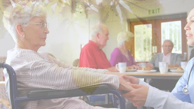 Animation of leaves over caucasian nurse with senior patient in wheelchair