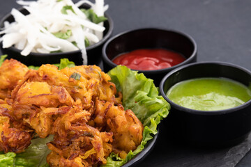 Indian Tea Time Snacks Fritters Onion Pakoda Also Called Pyaz Ke Pakore, Kanda Bhajji, Pyaj Bajji, Pyaaz Bhaji Or Pyaaj Pakora Is Deep Fried Street Food Enjoyed Across North And South India