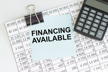 Financing Available text on the blue card next to the sheet with accounting reports and calculator. Financial concept