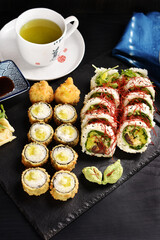 Japanese sushi set and green tea on black board