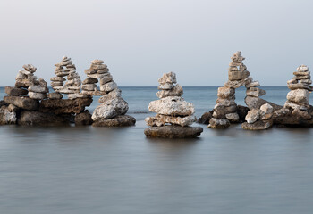 Stones Stacked in Ocean in Greece