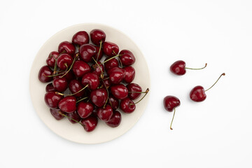 cherry in ceramic plate isolated on white