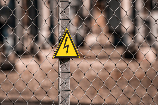 Electrical hazard sign placed on a fence of an electrical substation