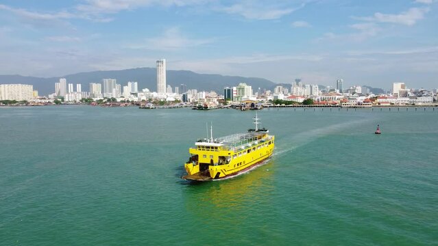 Penang, Malaysia: Aerial drone footage of the RORO car ferry leaving George Town in Penang island for Butterworth in Malaysia. Shot with a forward motion 