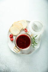 Raspberry jam or sauce with fresh rosemary