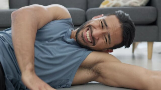 Man training body for fitness at home, sports exercise for wellness and motivation for healthy lifestyle. Strong, tired and Asian athlete doing crunches for cardio workout and performance in lounge