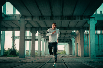 Runner in motion fast running. A sportsman have a workout outdoor. Concrete ambient. Sprinter.