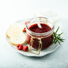 Raspberry jam or sauce with fresh rosemary