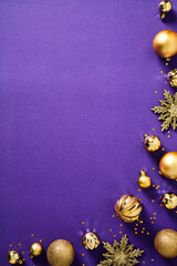 Christmas poster design. Purple Christmas vertical background with golden balls and ornaments. Flat lay, top view.