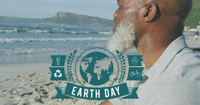 Animation of earth day text and globe logo over african american senior men on the beach