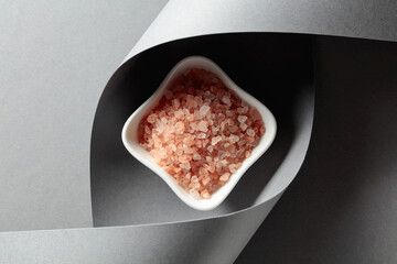 Pink salt in a white ceramic bowl.