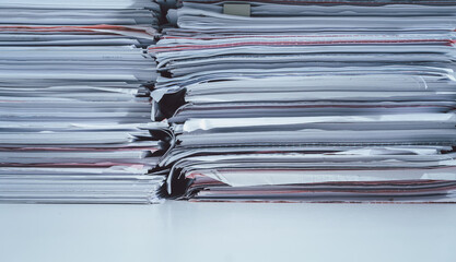 Many documents are stacked in the office.