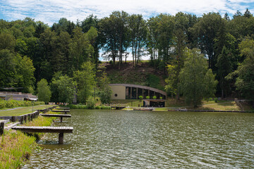 Fototapeta na wymiar modern camp by the lake equipped with piers and tiny sheds
