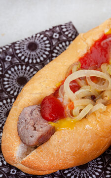 South African famous boerewors roll, juicy and topped with onions on a rustic surface