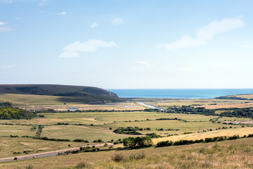 Fototapeta na wymiar Aerial view of the Cuckmere river and the English channel on a summer afternoon, East Sussex, England