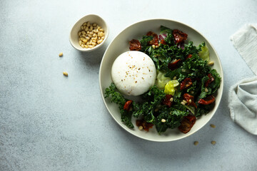 Healthy kale salad with fresh cheese and pine nuts