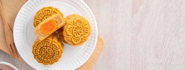 Delicious Cantonese moon cake for Mid-Autumn Festival food mooncake on wooden table background.