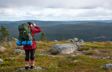 Woman hiking on mountain trail in Lapland Finland