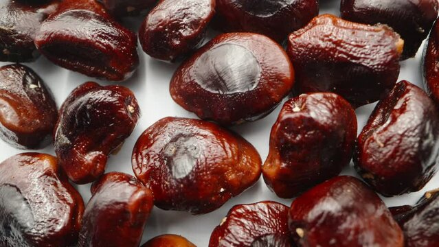 A handful of seeds from tamarind fruits. Dolly slider extreme close-up.