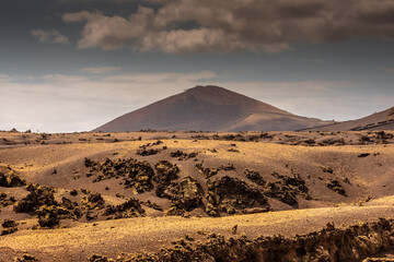 Fototapeta na wymiar Wild volcanic landscape of Los Volcanes Natural Park in Lanzarote, Canary Islands, Spain
