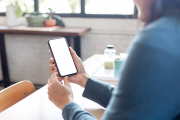 cell phone blank white screen mockup.hand holding texting using mobile on desk at office.background empty space for advertise.work people contact marketing business,technology