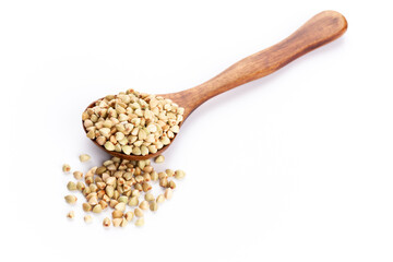 Raw buckwheat and wooden spoon on white background.