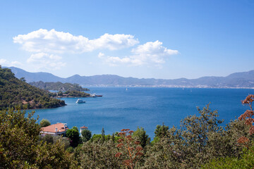 Landscape view of sea bay in Turkey from above. Seascape with blue sea water and mountains with green trees.