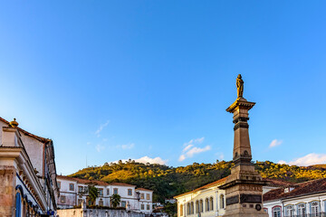 Fototapeta na wymiar Central square of the historic town of Ouro Preto surrounded by colonial-style houses and hills