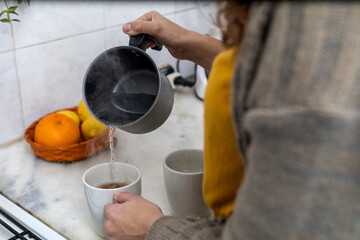 unrecognizable woman making tea
