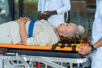 unwell senior woman had an accident and was immediately taken to an ambulance for treatment. © supAVADEE BUTRADEE