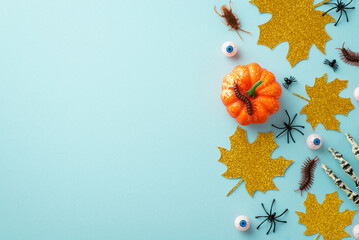 Halloween concept. Top view photo of pumpkin gold glitter maple leaves skeleton hand eyeballs...
