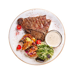 Portion of t bone steak with salad and sauce