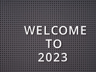 Words Welcome to 2023 spelled out with white letters on gray pegboard